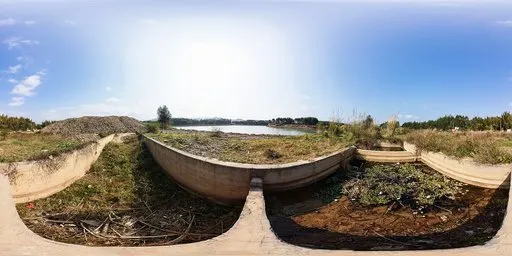 Daylit HDR scene with empty concrete pools by a river, overgrown foliage, and clear skies for realistic lighting setup.