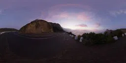 360-degree HDR of a soft pink sunrise over a tranquil mountain road scene.