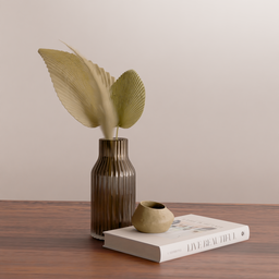 Dried palm leaf and pampas in glass vase