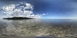 Clear coastal HDR image featuring sunlight reflecting on gentle sea waves with clouds overhead for realistic scene lighting.