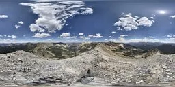 High-resolution panoramic HDR image featuring mountain peaks under a clear blue sky with bright sunlight.