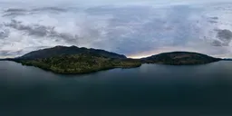 360-degree HDR panorama featuring a serene lake with surrounding mountains under a sunset sky.