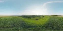 Panoramic HDR of lush green hills under a blue sky for realistic lighting in 3D indoor scenes.