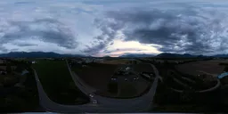 Aerial HDR featuring expansive farmland with mountains, under a vibrant sunset sky, perfect for scene lighting.