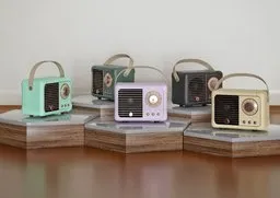 Variety of retro-style 3D modeled HMII speakers showcasing multicolor designs and Bluetooth functionality.