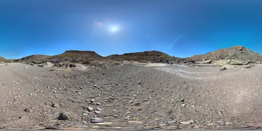360-degree HDR panoramic view of a mountainous rocky terrain with clear blue sky for scene lighting.