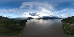 360-degree HDR panorama of a river with mountains during a cloudy sunset, ideal for scene lighting.