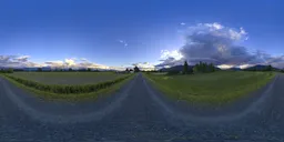 Vivid HDR panorama of a sunset over a serene farm road with dynamic sky in British Columbia.