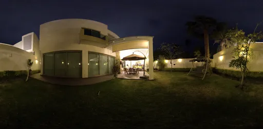 360-degree HDR panorama of a well-lit garden and patio area at dusk for realistic lighting in 3D scenes.