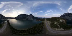 Aerial HDR panorama of a serene mountainous region with a sunset-lit sky, perfect for realistic scene lighting.