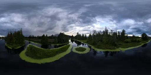 Dramatic storm clouds and sunset hues reflecting in tranquil river waters, surrounded by lush greenery.