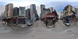 360-degree HDR urban panorama of a street with buildings under a blue sky for realistic lighting in 3D scenes.