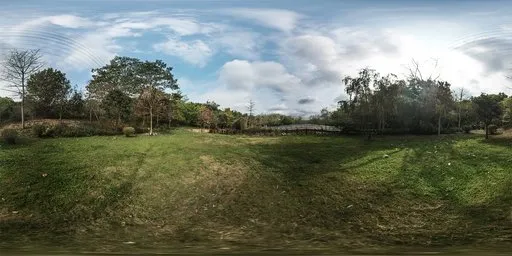 Vibrant panoramic HDR featuring expansive grassland with lush greenery under a clear blue sky with clouds.