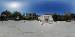 Sunny HDR panorama of a tranquil plaza with cobblestones and fountain for lighting 3D scenes.