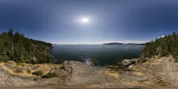 360° HDR panorama for lighting, featuring clear skies, ocean views, with rocks and foliage.