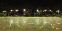 Illuminated outdoor basketball court at night with surrounding foliage for scene lighting HDR.