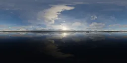 Stunning high dynamic range image capturing the reflection of sunrise over a tranquil lake with mountainous backdrop.
