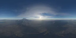 High-resolution aerial HDR environment with cloudy sunset over mountainous terrain for realistic scene lighting.