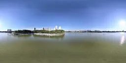 360-degree HDR panorama featuring tranquil lake waters with urban skyline and clear skies for realistic scene lighting.