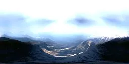 Ethereal mountain valley HDR with diffused sunlight and 360-degree snowy peak panorama.