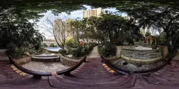 Scenic HDR lighting scene featuring a curved wooden bridge with lush foliage and urban backdrop for realistic environment rendering.