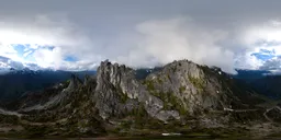Cloud-capped rocky peaks with lush greenery in a 360-degree HDRI panorama, ideal for scene lighting.