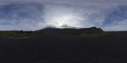 360-degree HDR panorama of a cloudy mountainous skyline with an empty road for realistic scene lighting.