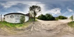 360-degree HDR panorama with a white building, dirt roads, trees, and scattered clouds for realistic lighting.