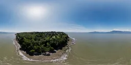 High-resolution aerial HDR panorama of a coastal city beach with rocky shores under a clear sky.