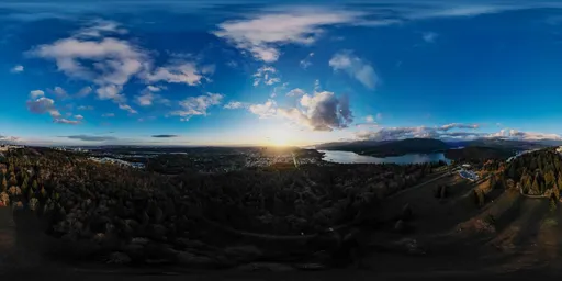 360-degree panoramic HDRI of sunset over urban skyline, with dramatic clouds and lighting for 3D scenes.