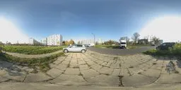 17k HDR image depicting a sunlit parking area with vehicles and apartment buildings, taken in Warsaw during Fall.
