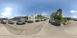 360 degree panoramic urban HDR image featuring sunny car park with clear blue sky.