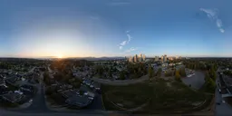Aerial HDR panorama for scene lighting capturing the warm glow of sunset over a bustling urban landscape.