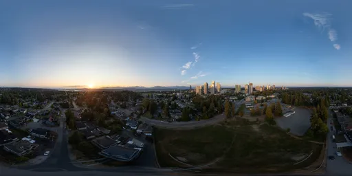 Aerial HDR panorama for scene lighting capturing the warm glow of sunset over a bustling urban landscape.