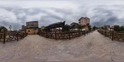 Panoramic HDR image featuring a riverside urban landscape with roads, railings, residential buildings, and lush green trees.