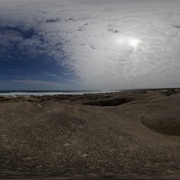 360-degree HDR panorama of a cloudy sky over a rocky terrain for realistic lighting in 3D scenes.