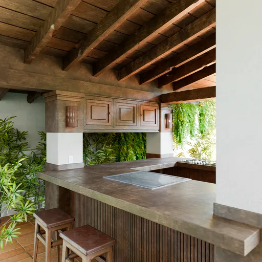Rendered 3D Mexican-style kitchen with wood beams, concrete counter, and lush plants for Blender modeling.
