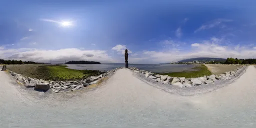 360-degree HDR panorama for lighting with vibrant blue sky, sun flare, and clear coastal path.