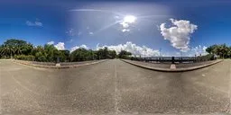 360-degree panoramic HDR image featuring a sunlit highway with a river alongside, clear sky, and lush trees for scene lighting.