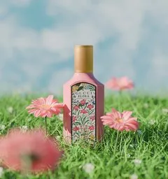 3D modeled scene with perfume bottle on grass field for Blender visualization.