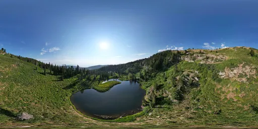 360-degree panoramic HDR image featuring vibrant grassland, serene lake, and clear blue sky.