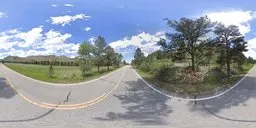 360-degree HDR panorama with road, greenery under a clear blue sky for realistic lighting in 3D scenes.