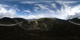 360-degree HDR panorama featuring a cloudy sky above a rugged mountainous terrain for scene lighting.